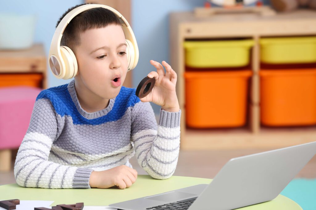 Boy at computer with headphones on