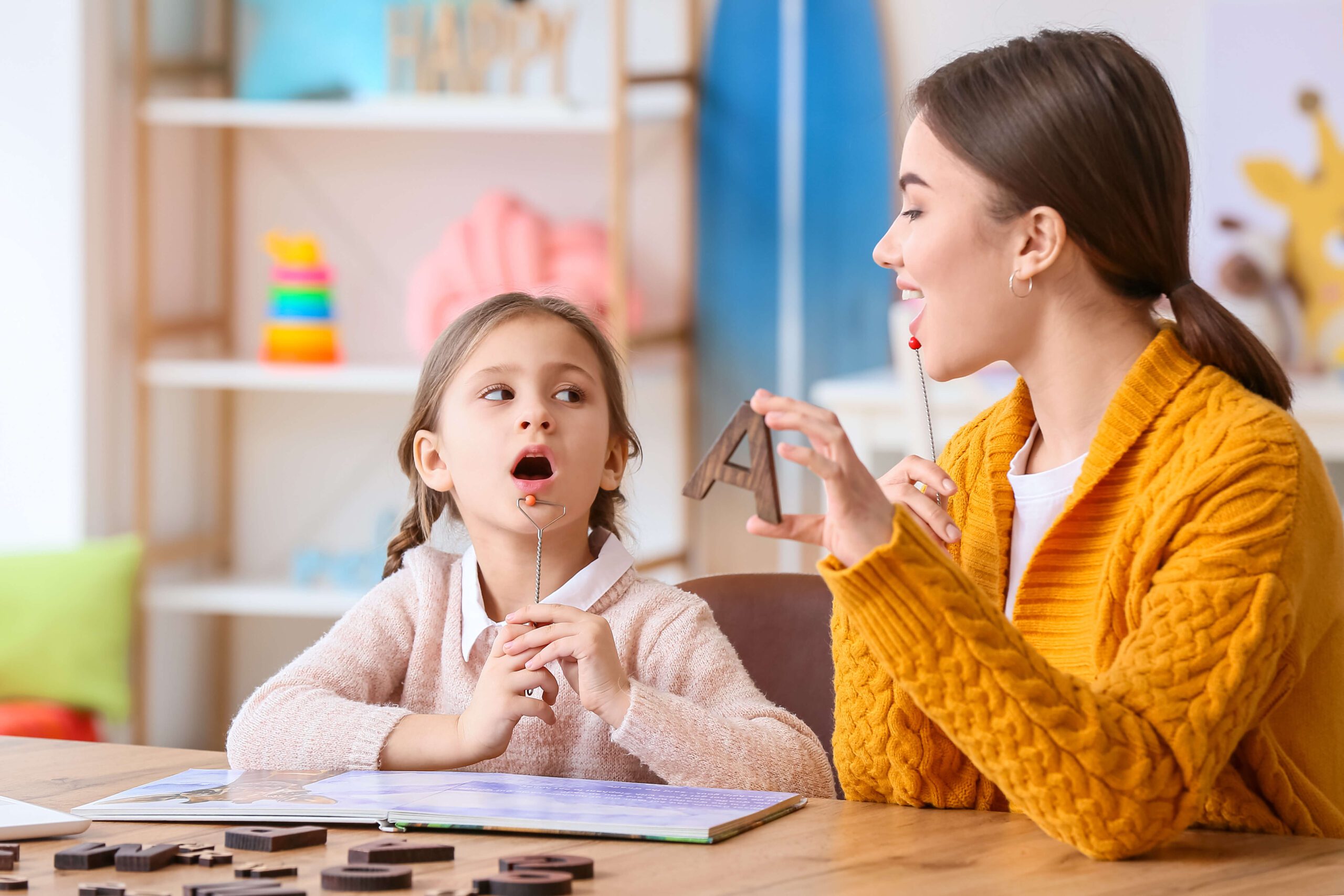 Speech teacher with elementary school girl