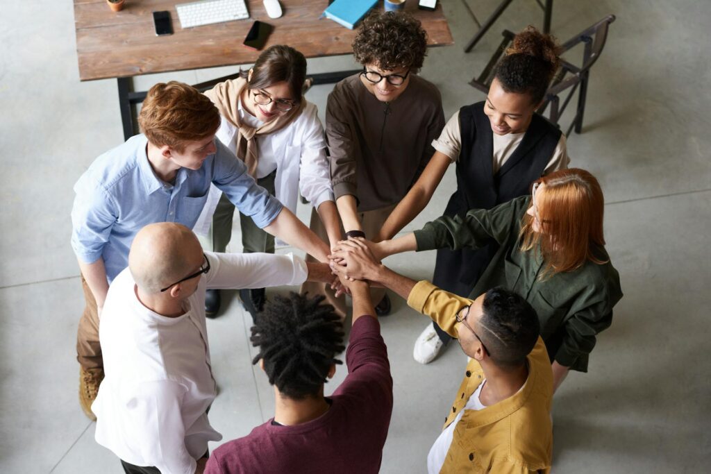 SLP employees stack their hands in a circle.