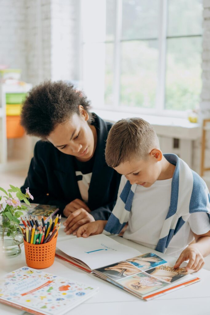 An SLP employee works with a child in a school’s classroom.