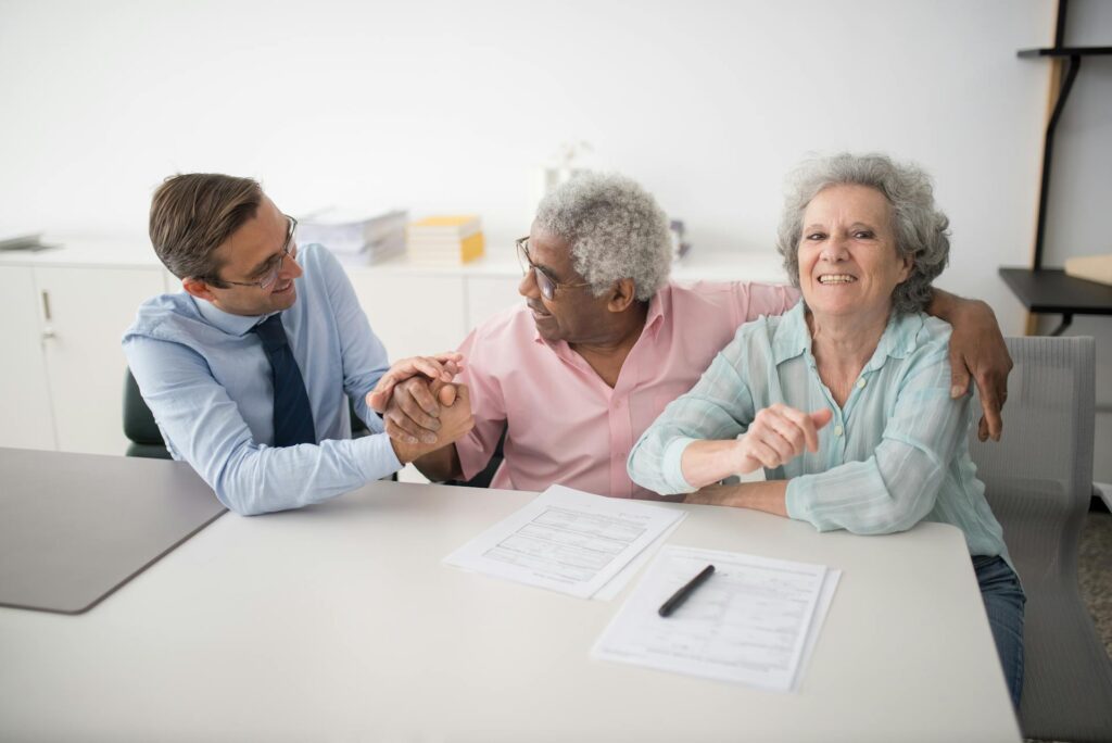 A speech pathologist meets with an elderly couple when the job outlook for speech pathologists is high.